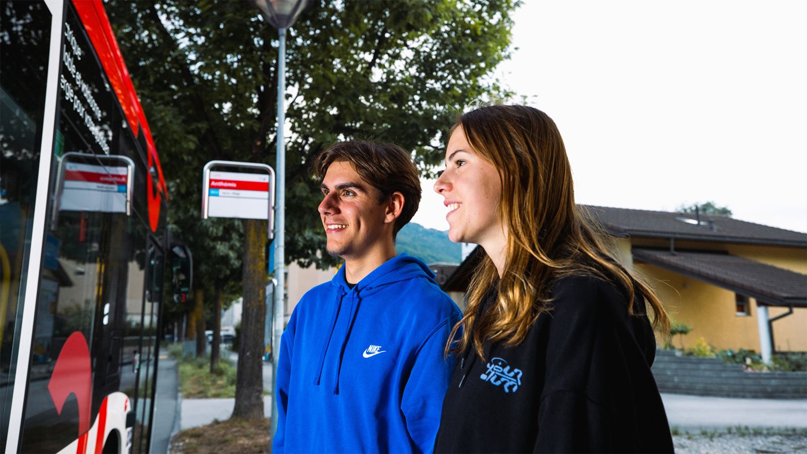 Young couple leaving the bus in the evening
