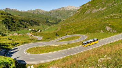 A Postbus drives down the Julier Pass.