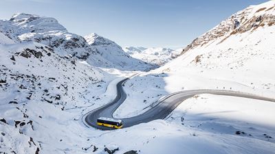 A Postbus drives down the Julier Pass.