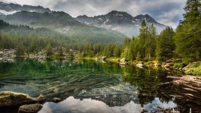 Mountains reflected in the crystal clear Lago di Saoseo.