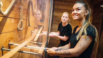 Two women solve a puzzle in a room at Boda Borg Rümlang.