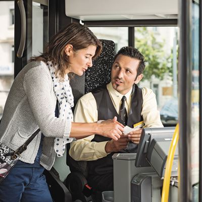 A Postbus driver talking to a passenger