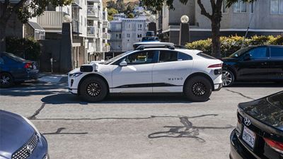 Waymo’s autonomous vehicle driving through a residential area in the USA